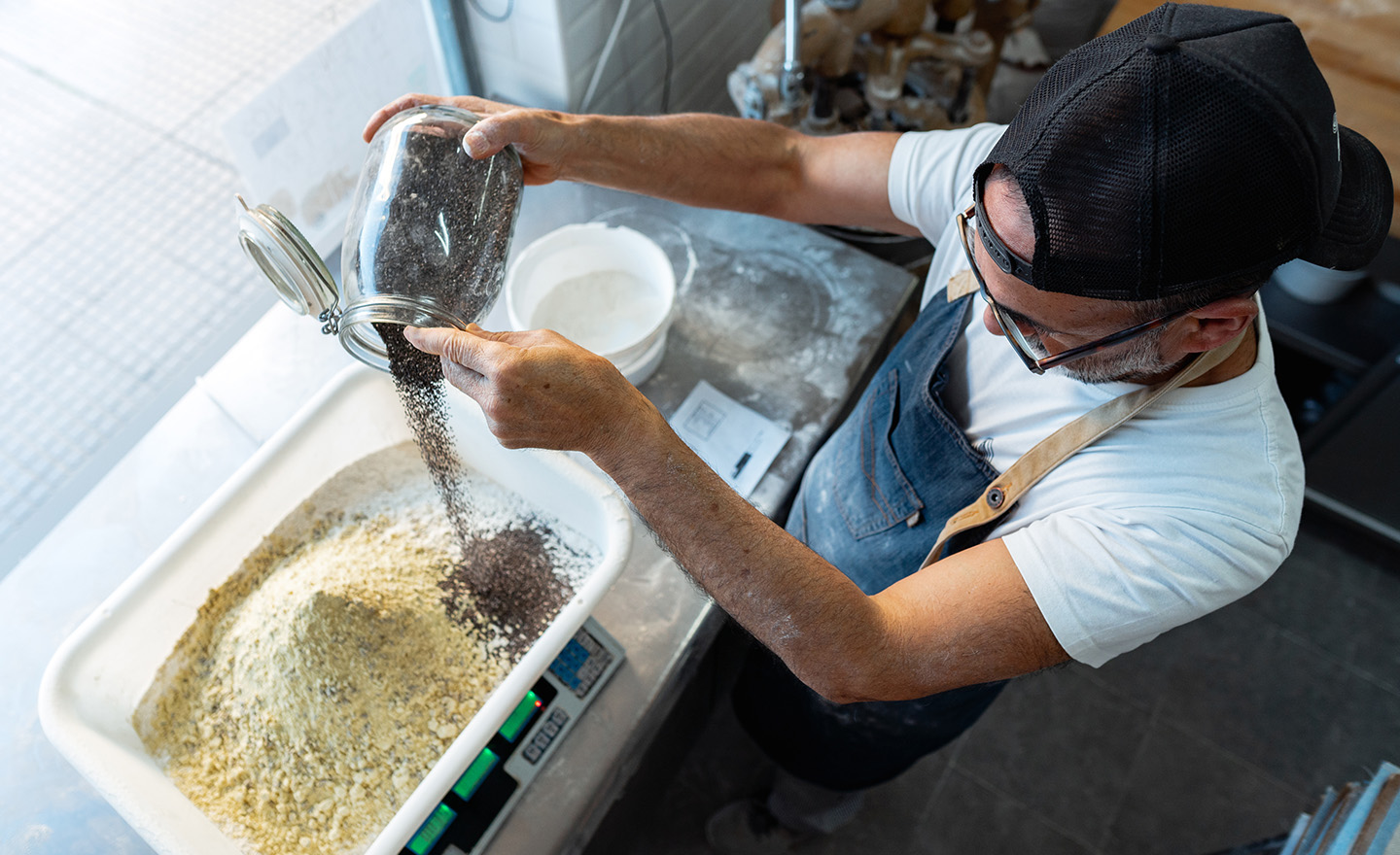 Baker adding food ingredients representing Sagentia Regulatory's food ingredients and GRAS services