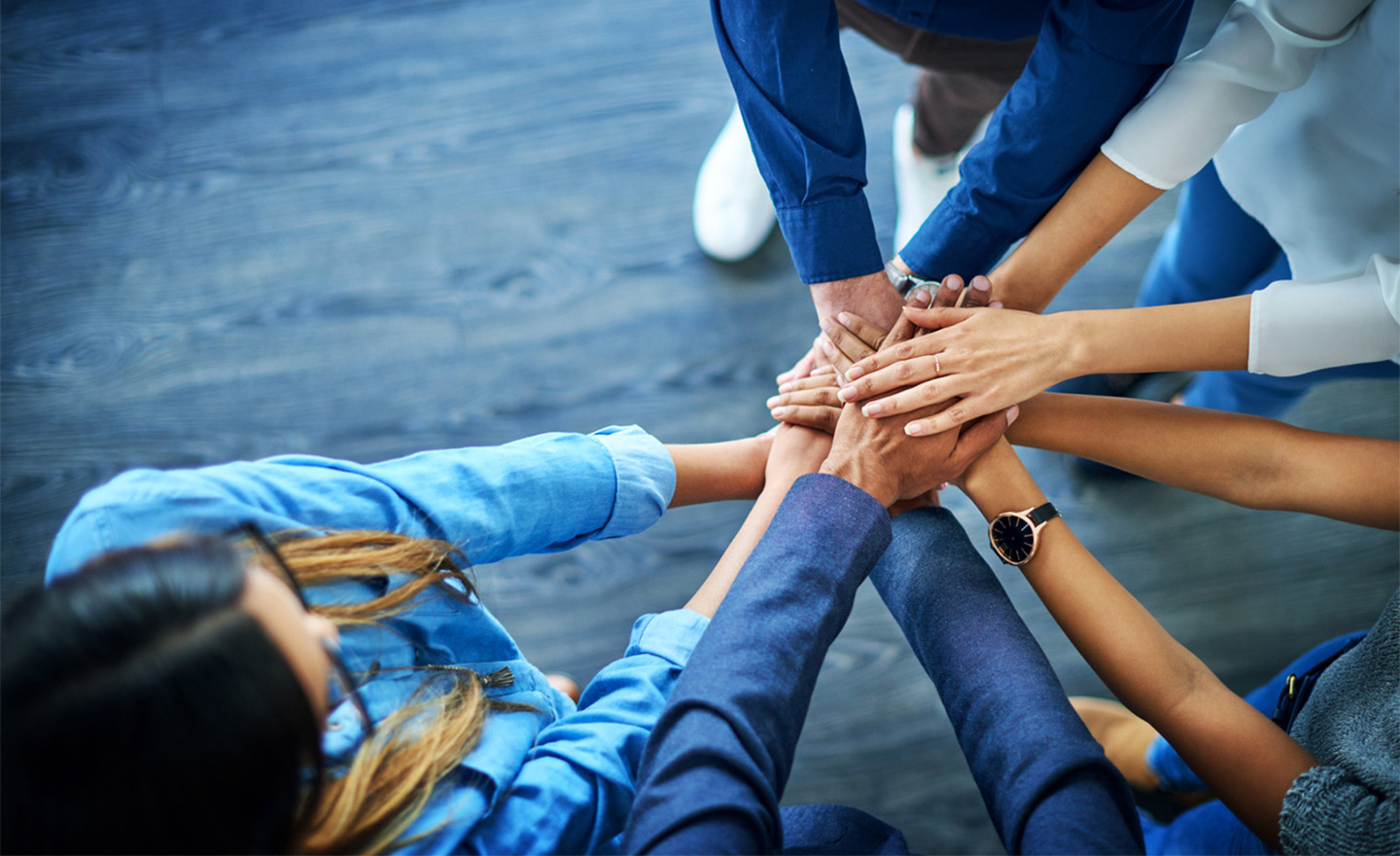 Team stacking hands representing Sagentia Regulatory's scientific and regulatory experts