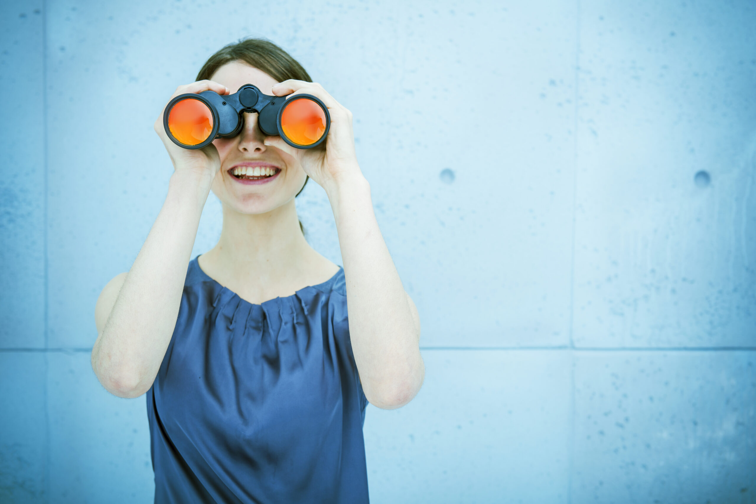 Woman with binoculars representing Leatherhead Food Research's Horizon Scanning Services