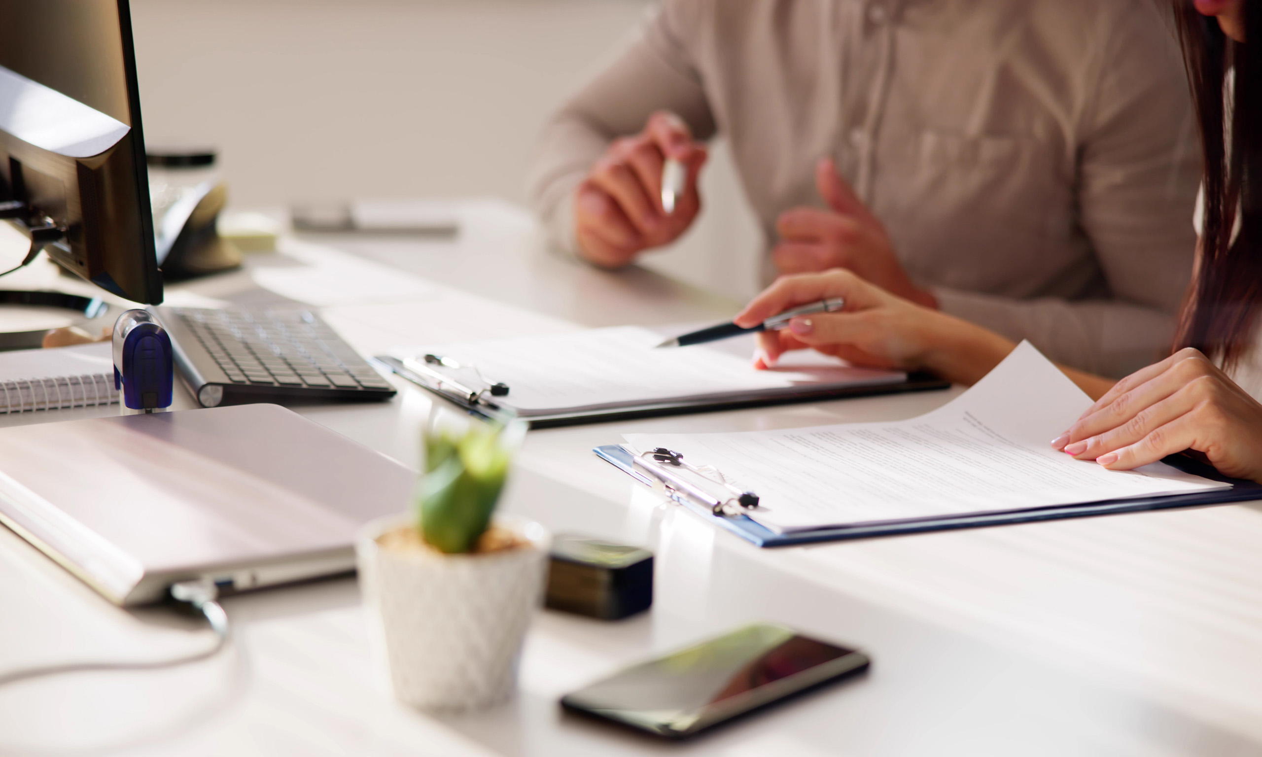 Two people reviewing documents representing TSCA PFAS Reporting | Sagentia Regulatory