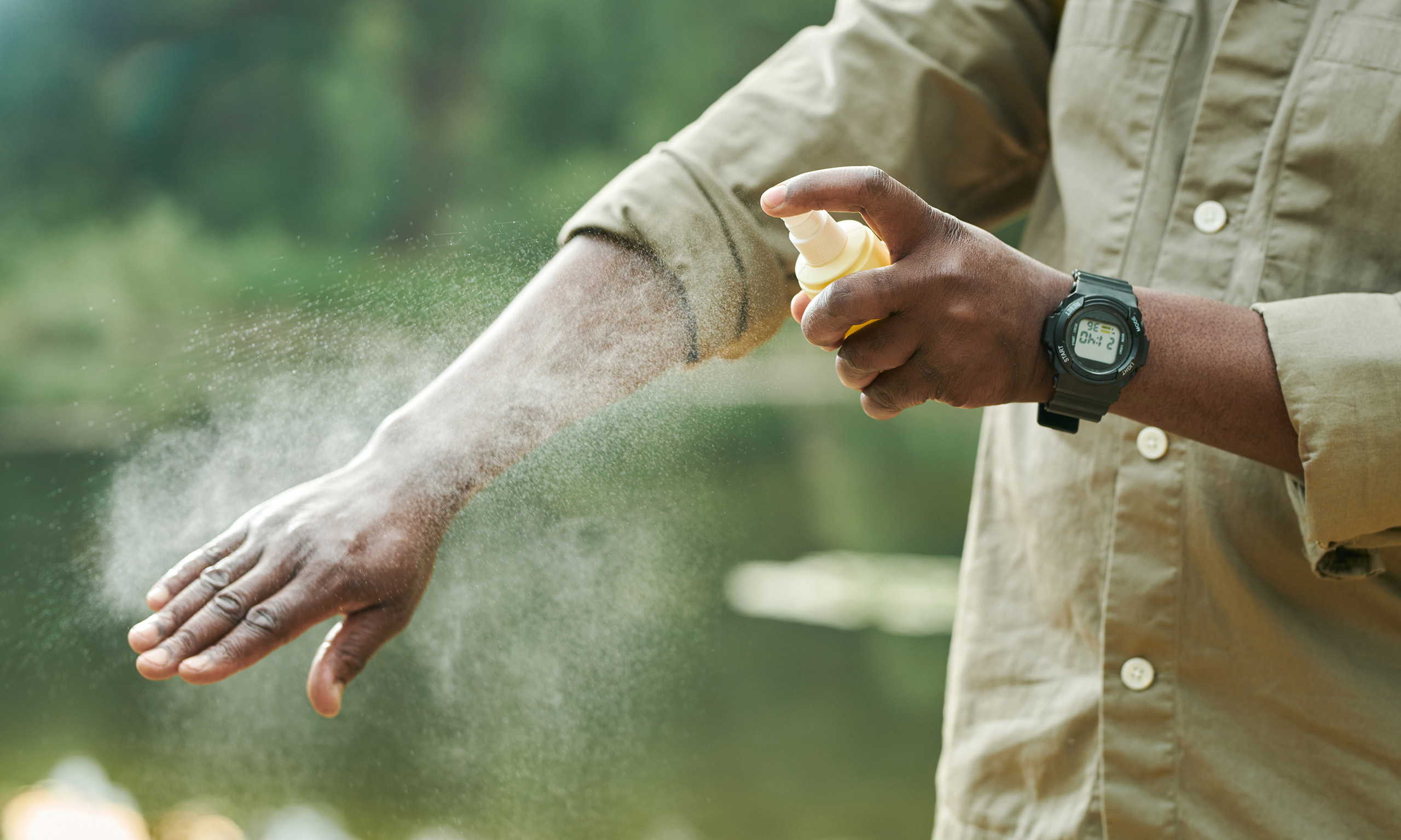 Person spraying mosquito repellent representing Sagentia Regulatory's pesticide registration services in USA