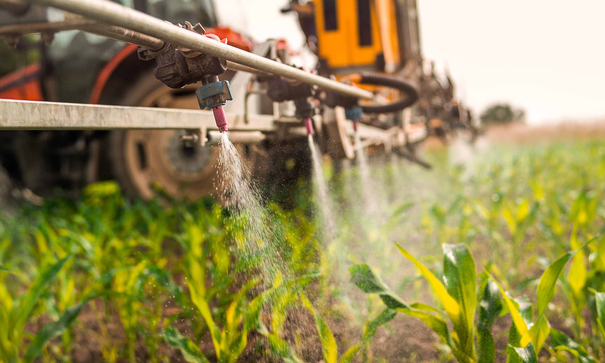 Applying pesticide to field, representing Sagentia Regulatory's pesticide scoping document services