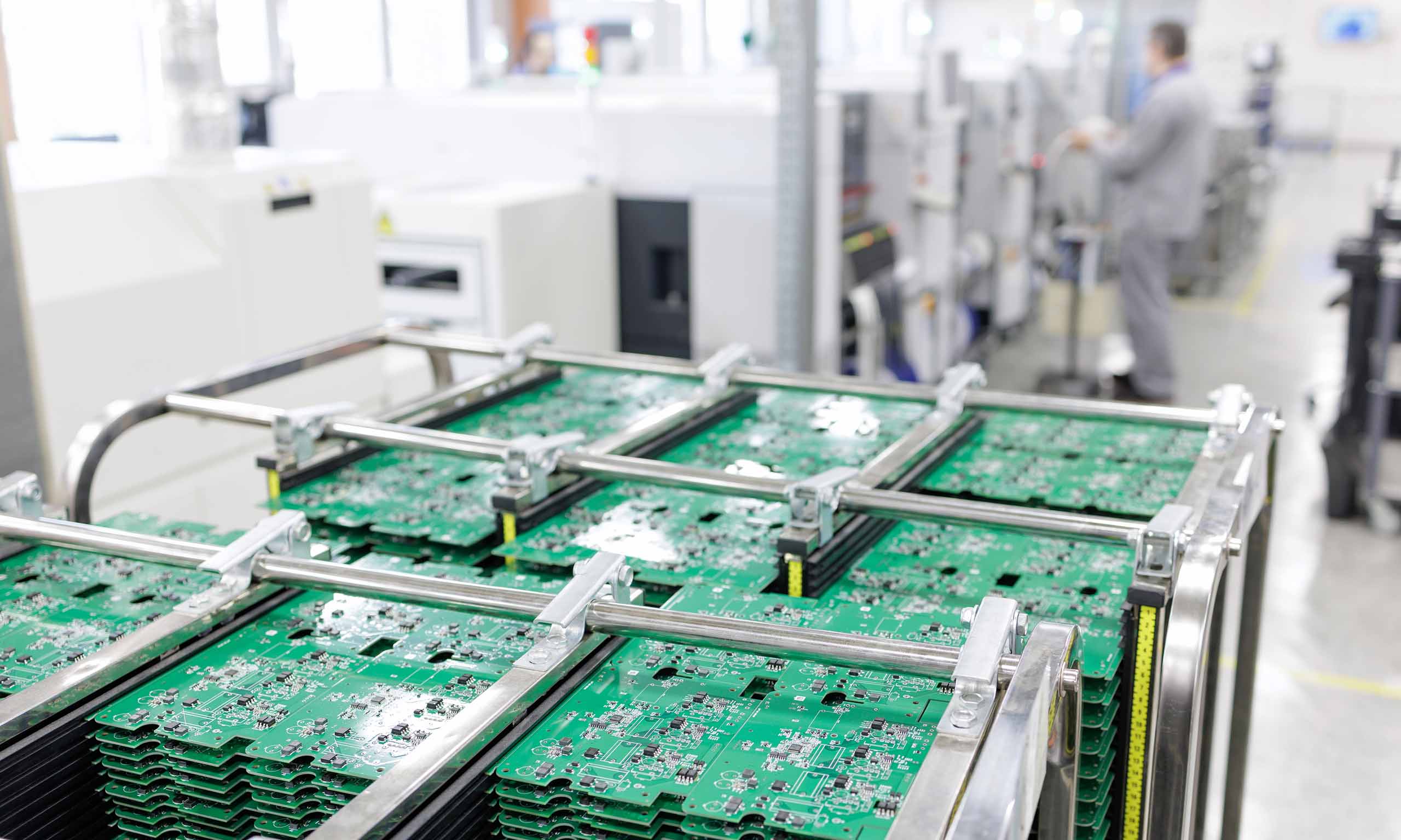 Stacked PCB panels representing Sagentia Regulatory's TSCA compliance services for treated articles